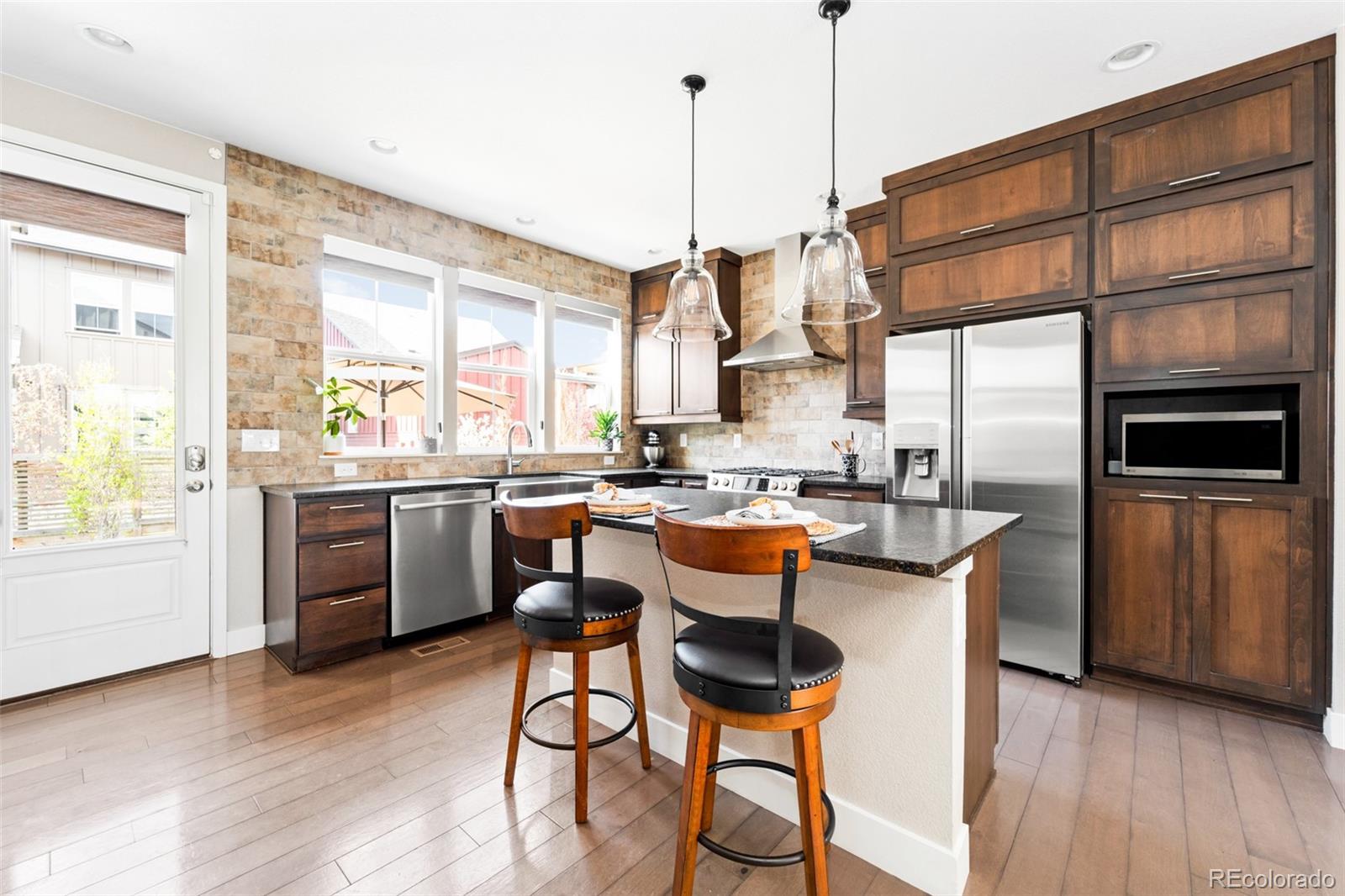 a kitchen with a sink window and cabinets