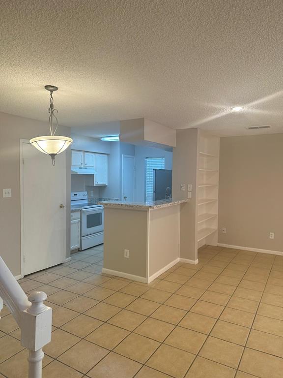 a view of a kitchen with a sink and cabinets