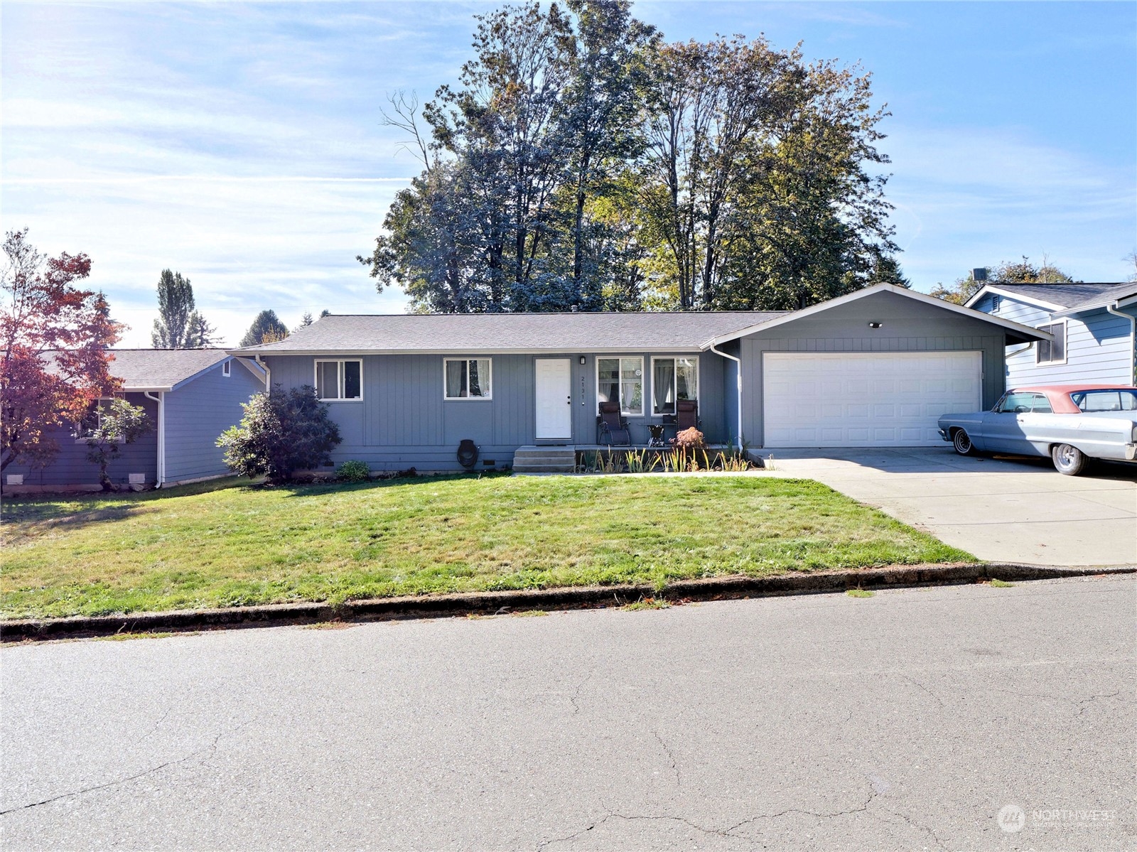 front view of house with a yard and potted plants