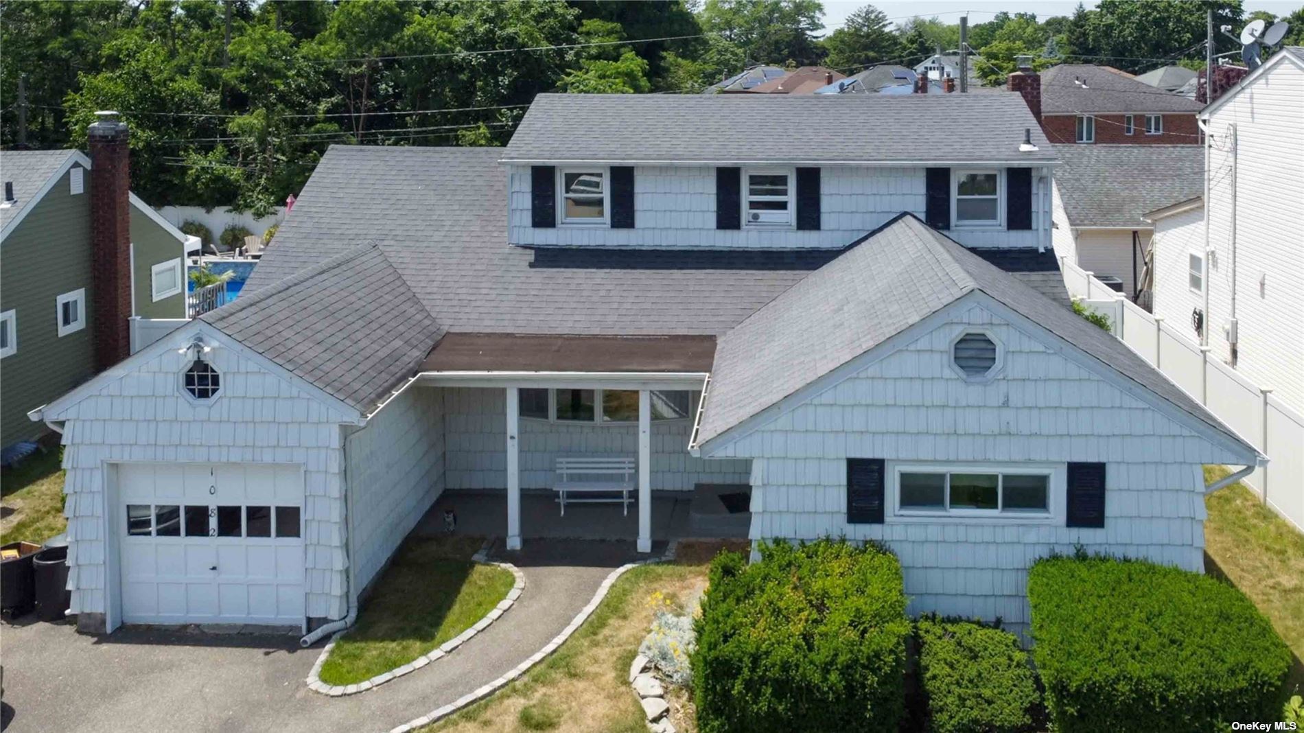 a aerial view of a house next to a yard