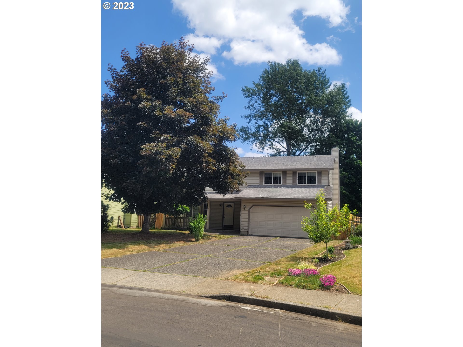 a view of a house with a yard and garage