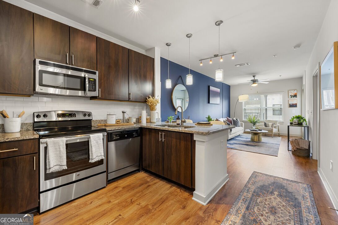 a kitchen with stainless steel appliances granite countertop a stove and a sink