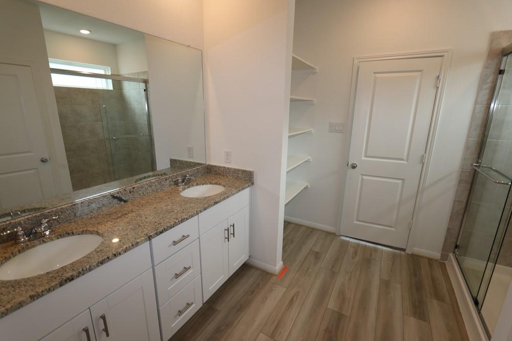 a bathroom with a granite countertop sink toilet and shower