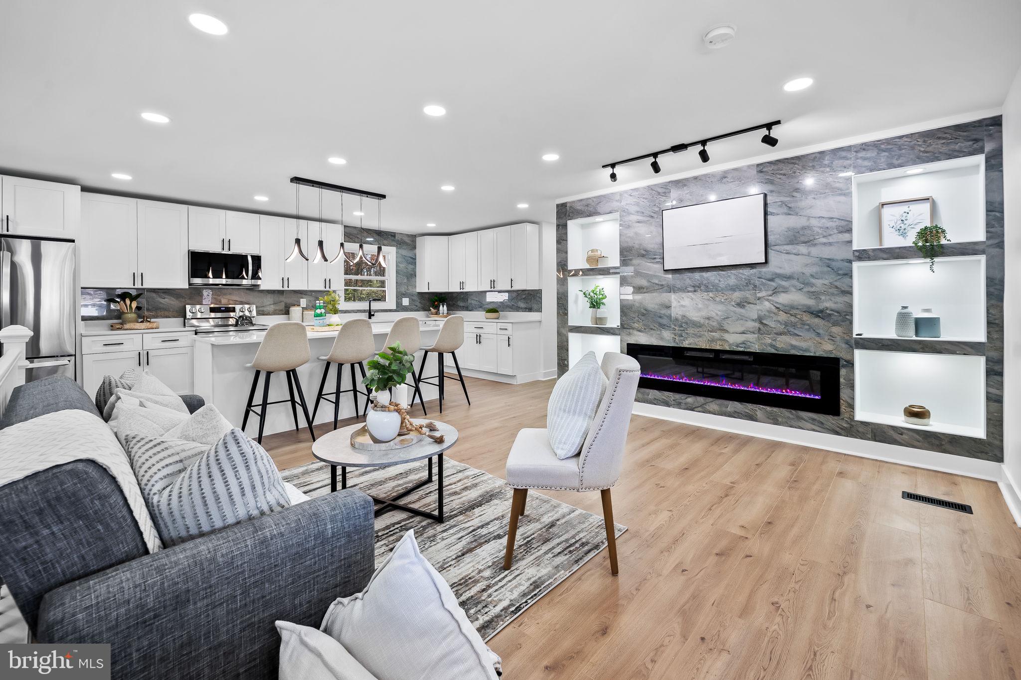 a living room with lots of furniture and kitchen view