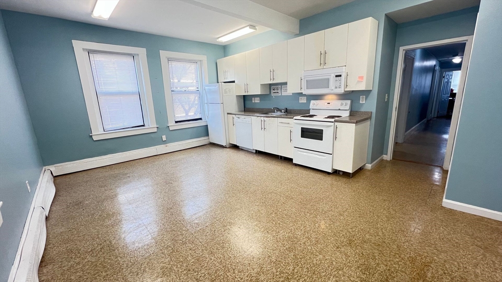 a kitchen with stainless steel appliances a refrigerator sink and cabinets