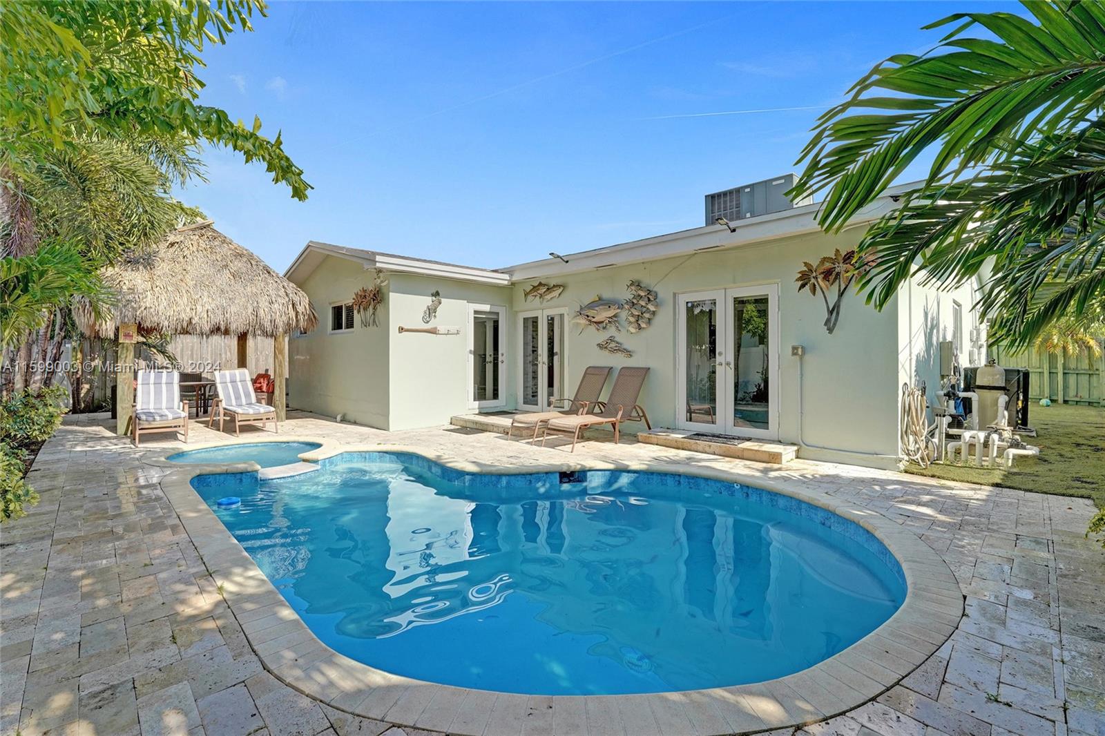 a view of a house with swimming pool and sitting area