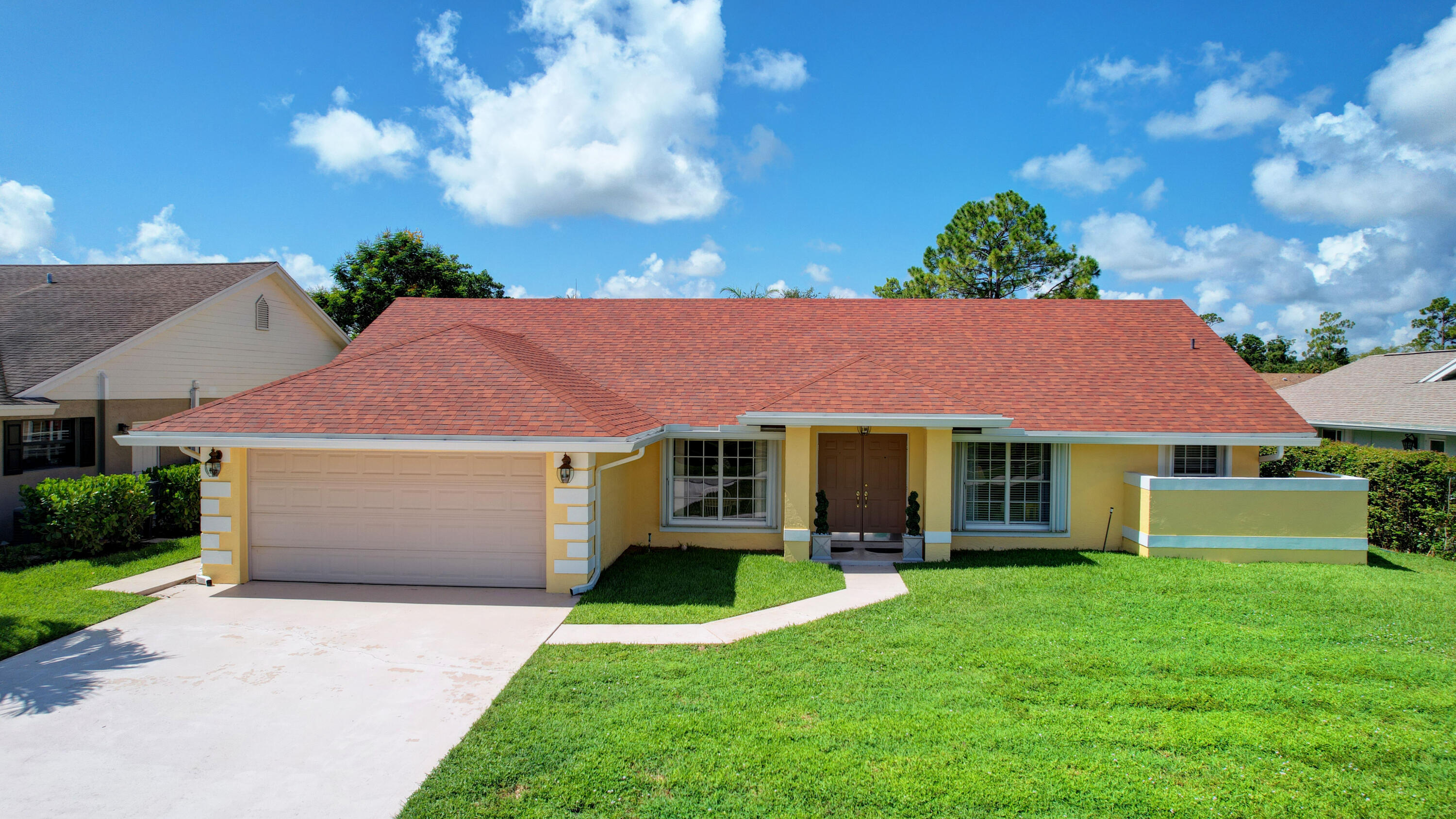 a front view of a house with a garden and yard