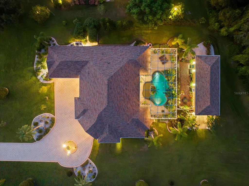 an aerial view of a house with yard swimming pool and outdoor seating