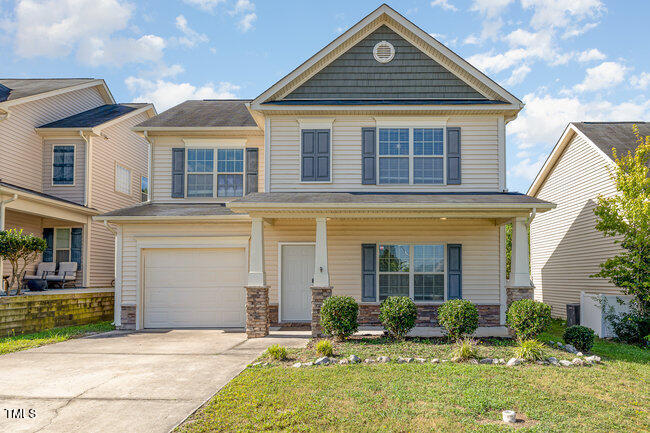 a front view of a house with yard and porch