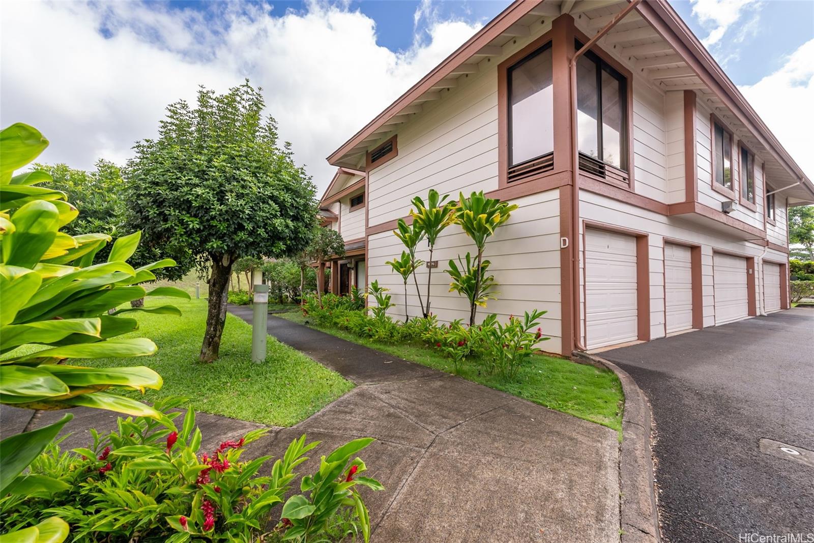 a front view of a house with garden