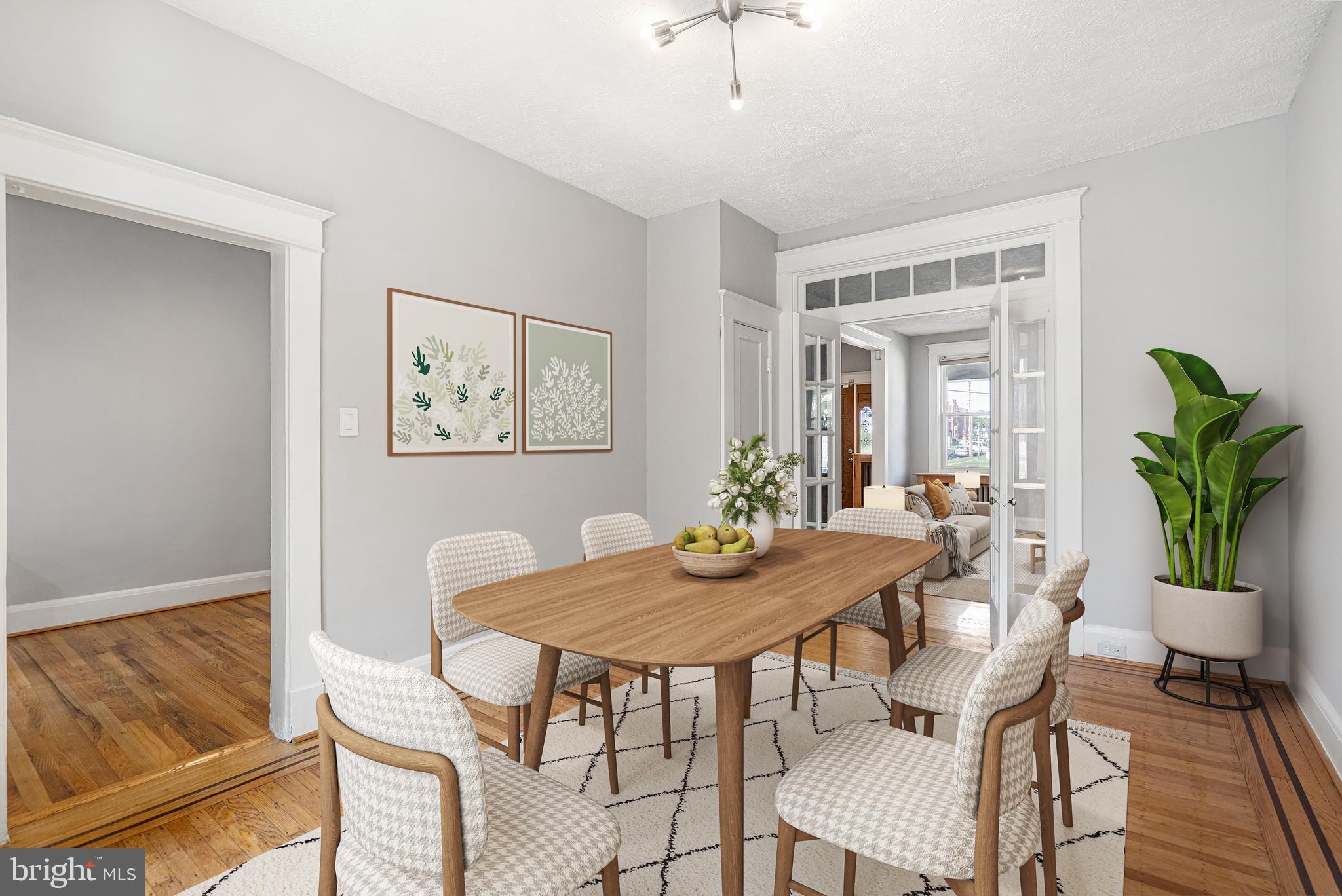 a view of a dining room with furniture and a potted plant