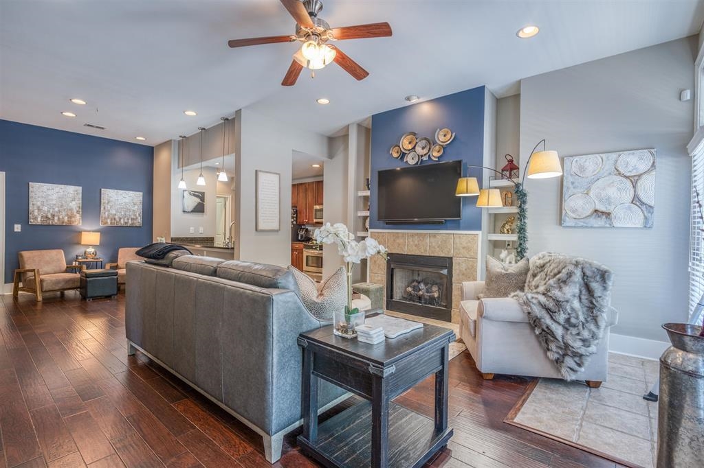 a living room with furniture a fireplace and a flat screen tv