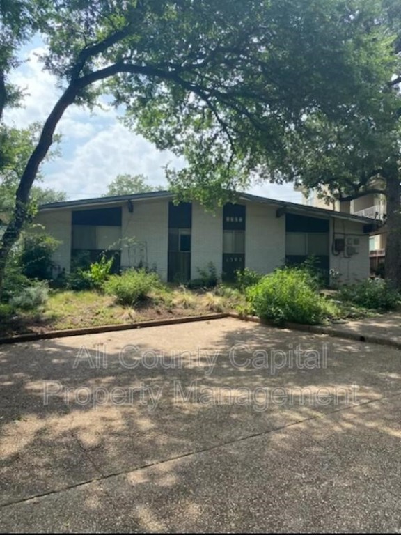 a front view of a house with a yard and a garage