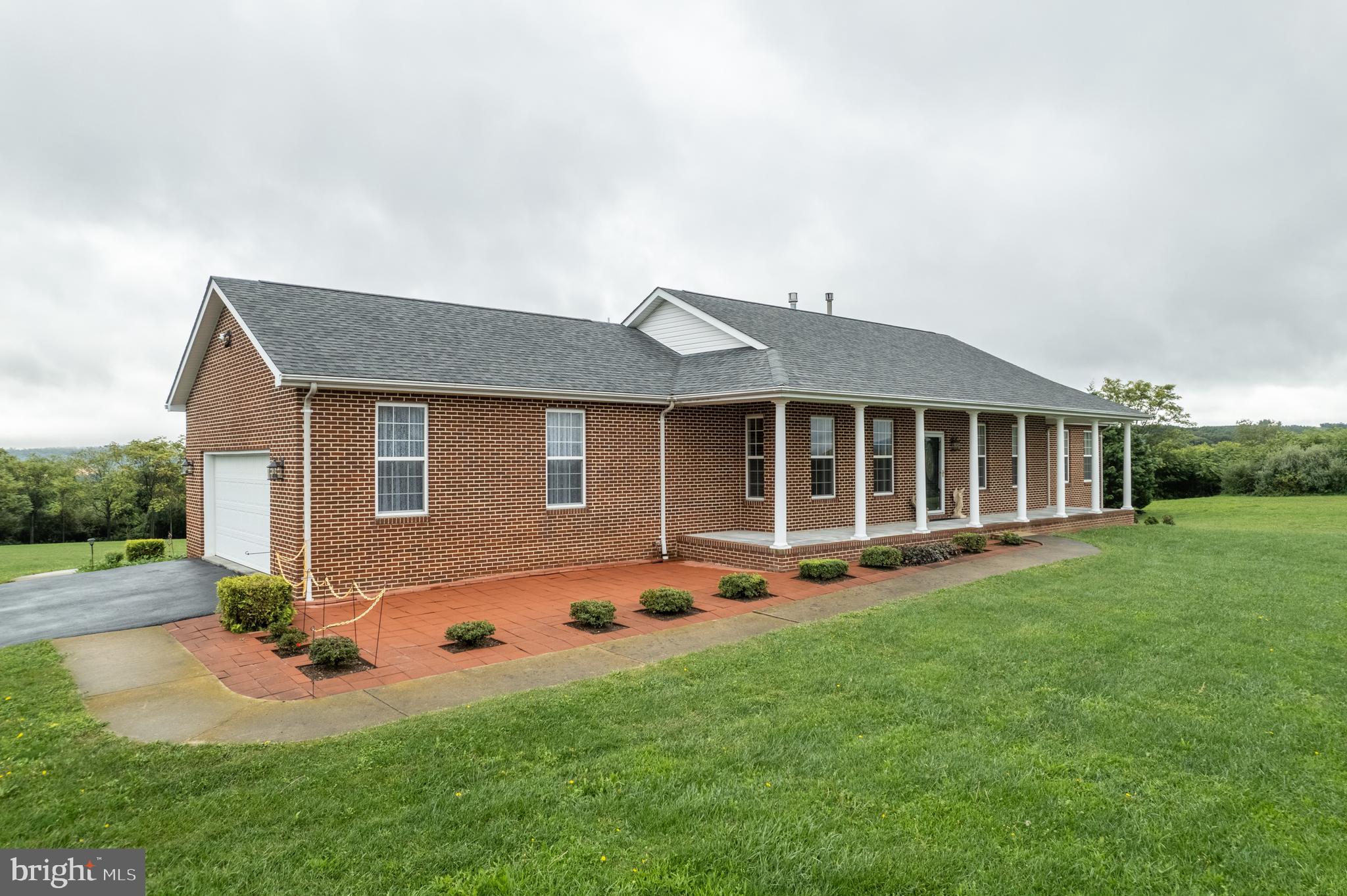 a front view of house with yard and green space