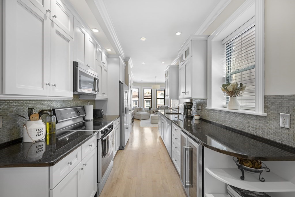 a kitchen with kitchen island granite countertop lots of counter top space and a sink