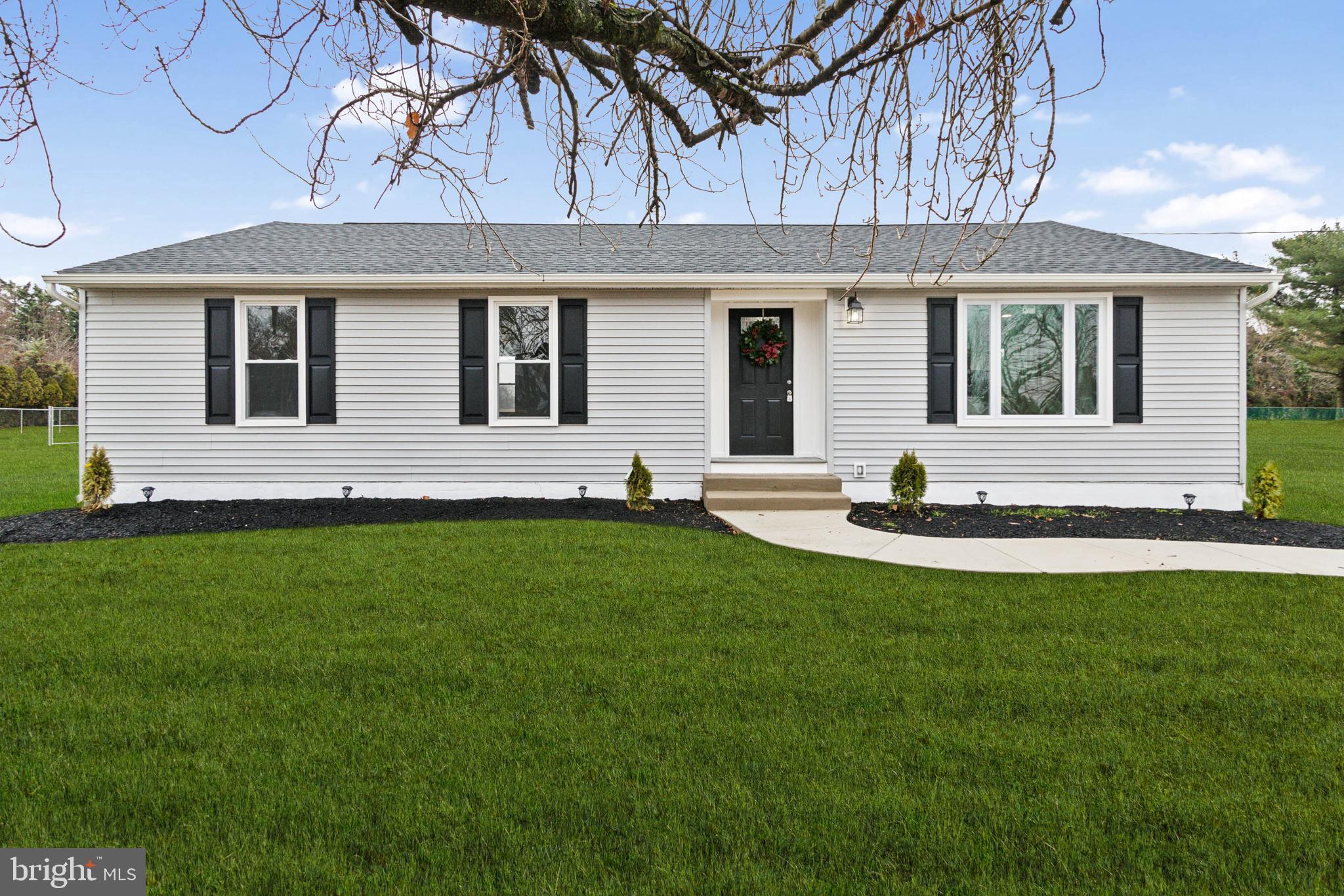 a front view of house with yard and outdoor seating