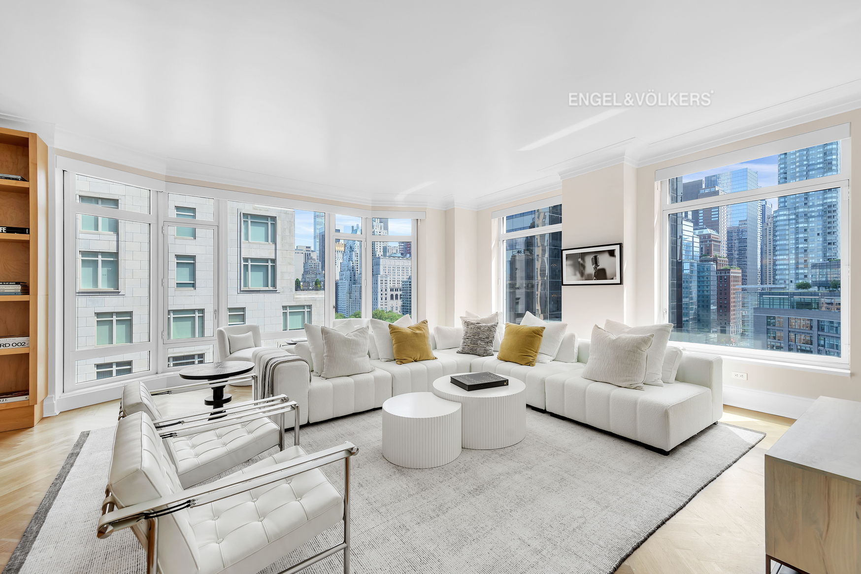 a living room with furniture and large windows