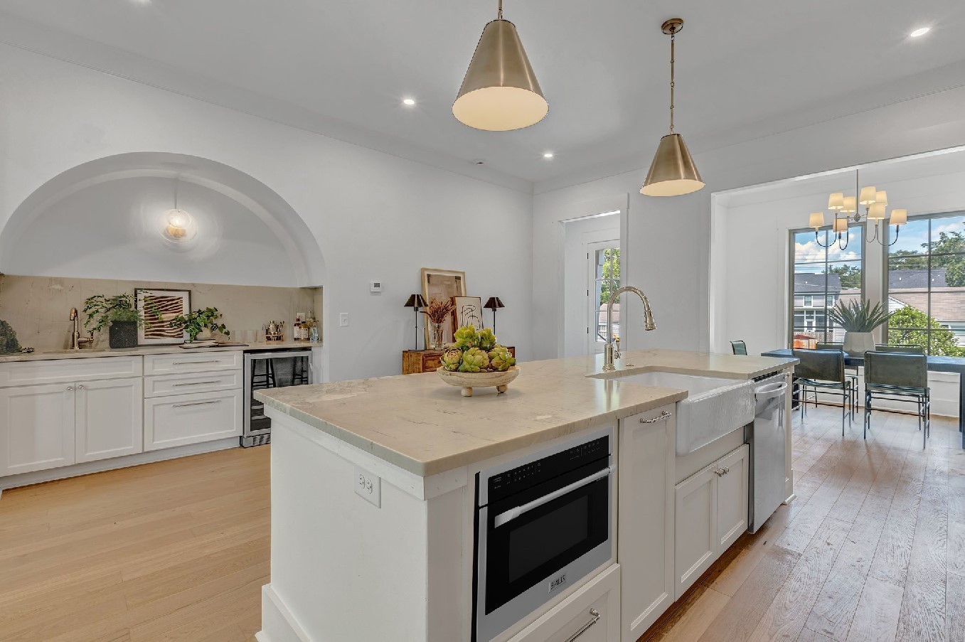 a kitchen with a stove a sink a dining table and chairs