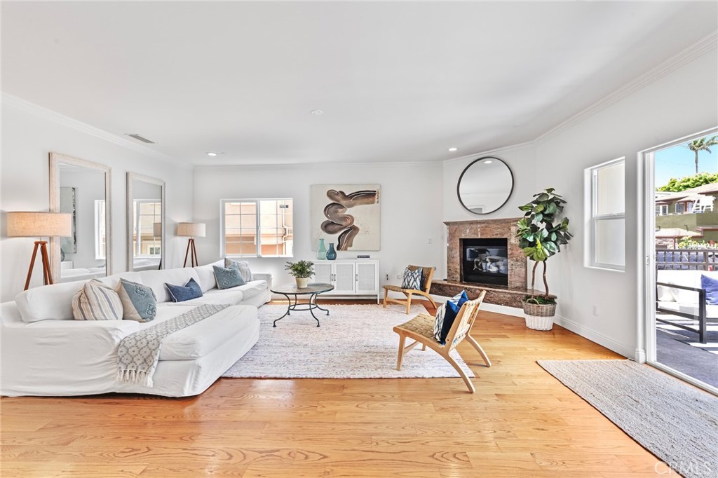 a living room with fireplace furniture and a large window