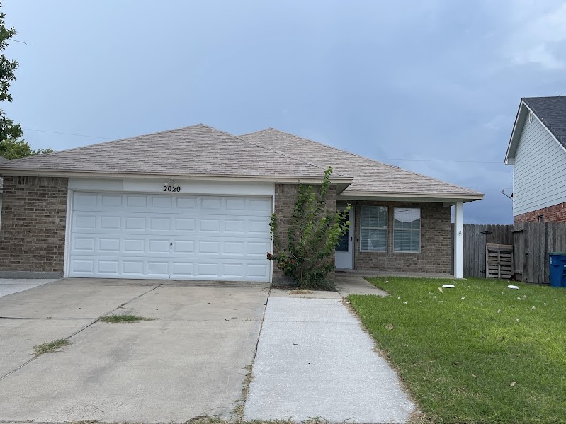 a view of a house with a yard and garage