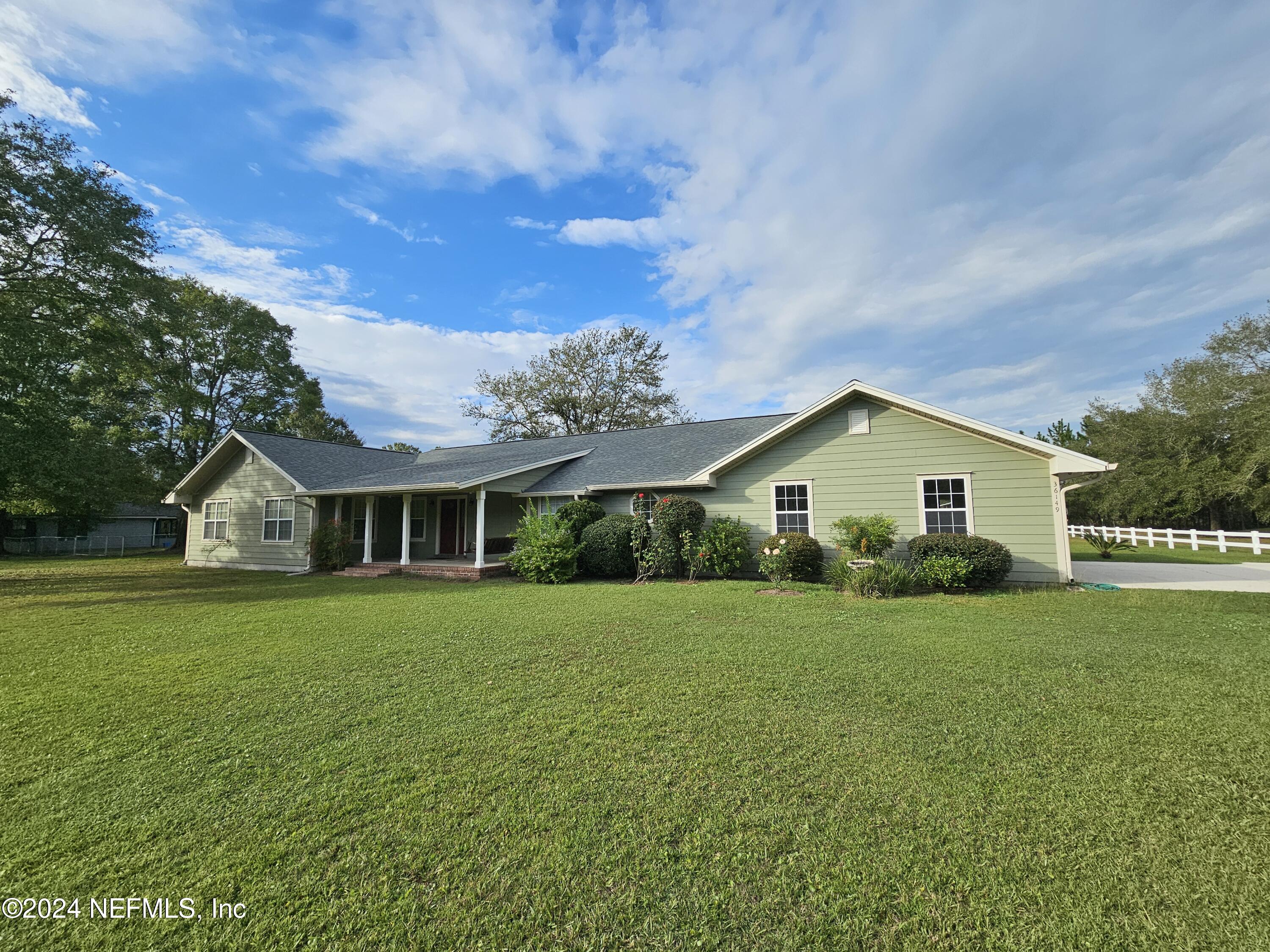 a front view of house with yard and green space