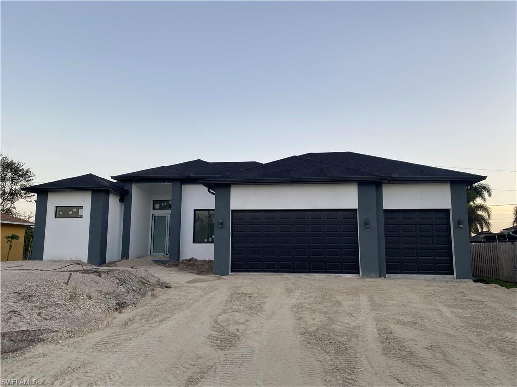 a view of a house with a yard and garage