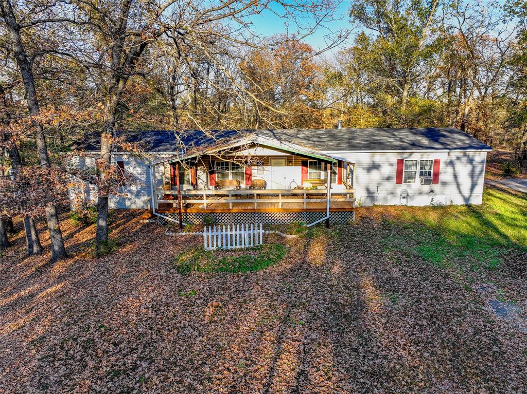 a view of a house with a yard and sitting area