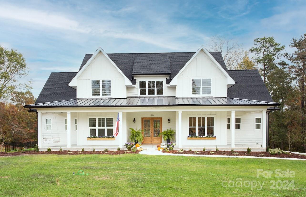 a front view of a house with a garden and yard