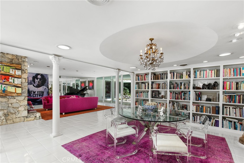 a living room with furniture and a book shelf