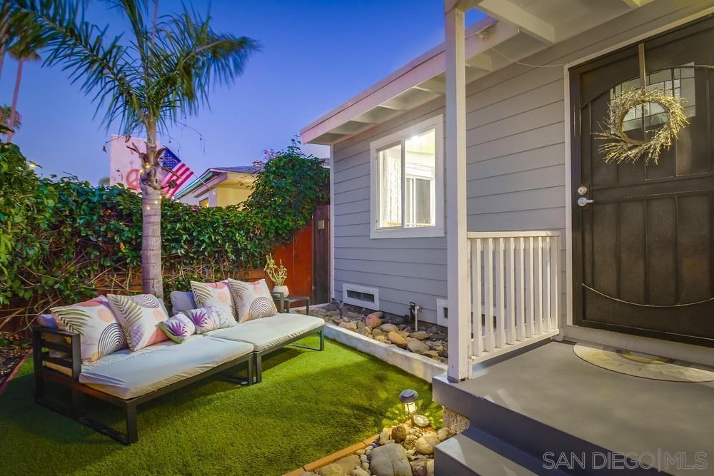 a view of a house with backyard and sitting area