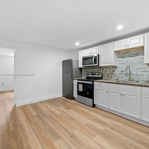 a kitchen with granite countertop a refrigerator stove and microwave