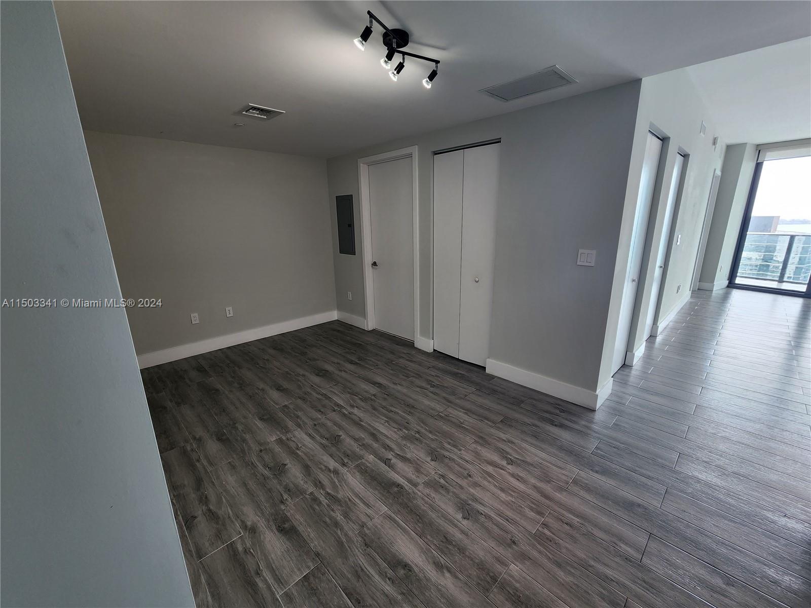 wooden floor in an empty room with a window