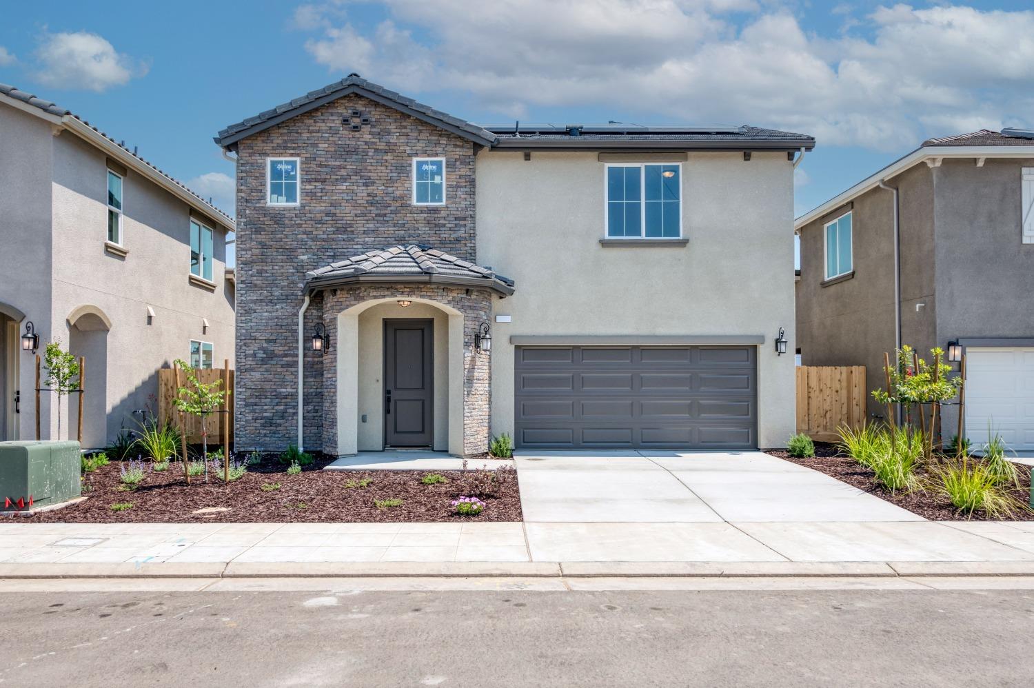 a front view of a house with garage