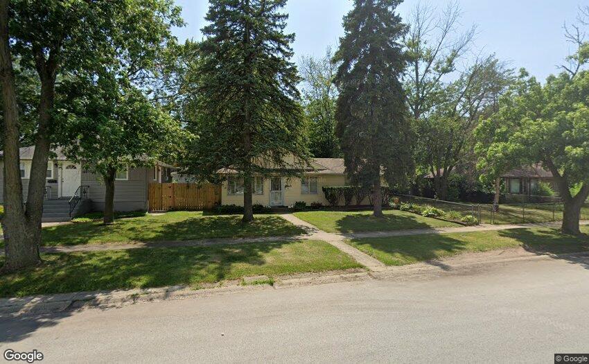 a view of a house with backyard and a tree