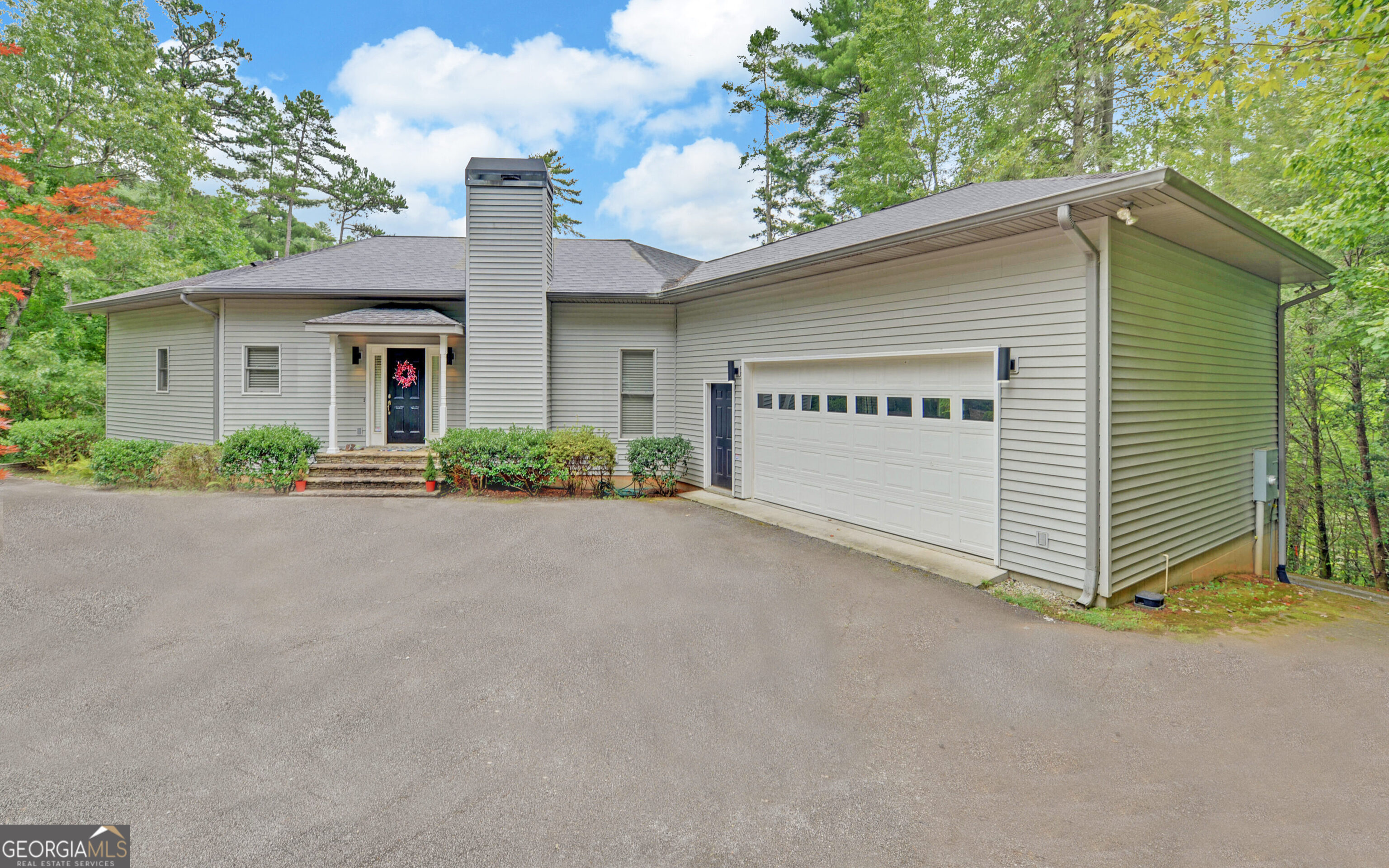 a view of a house with a yard and garage