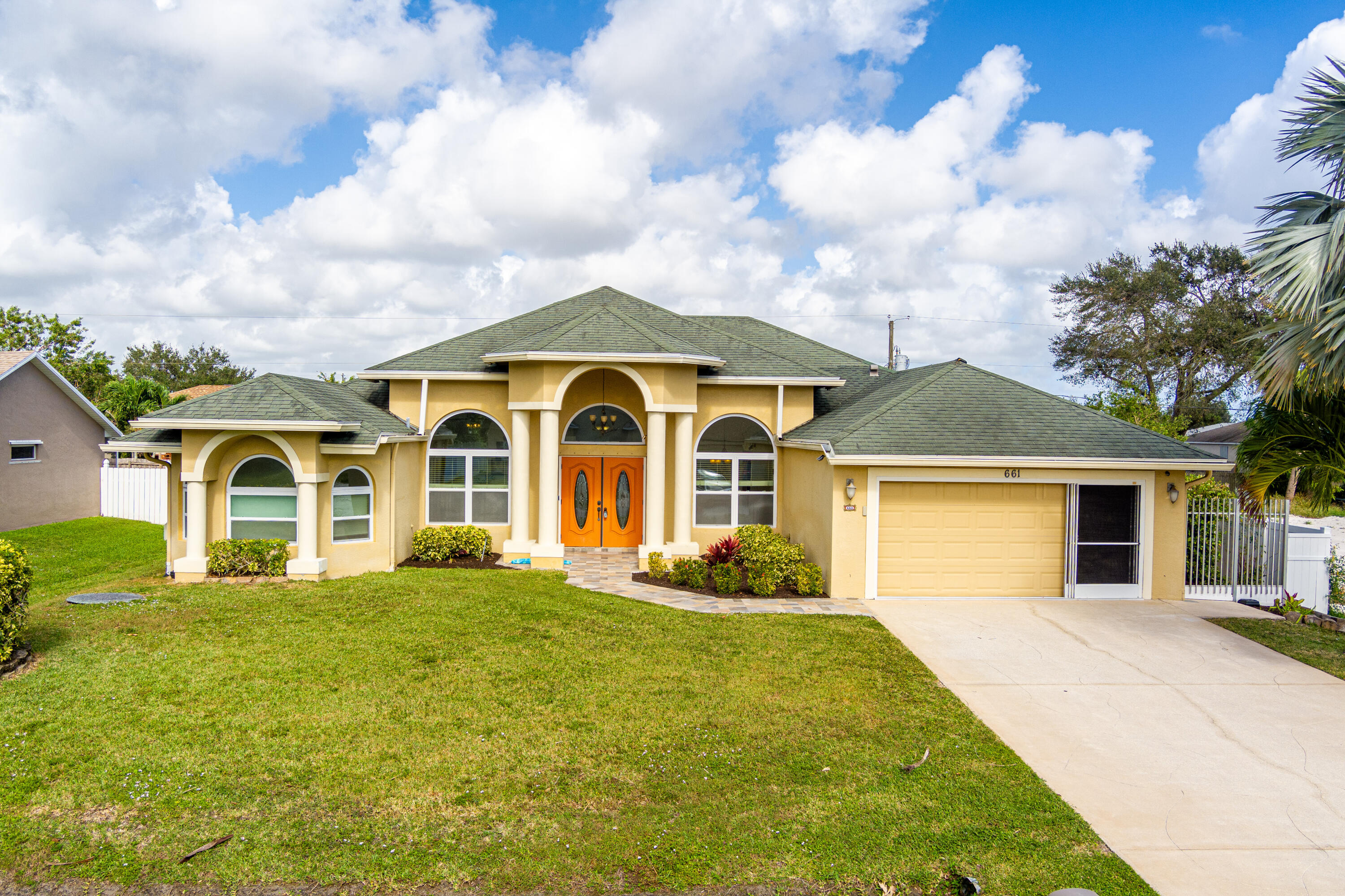 a front view of a house with a garden