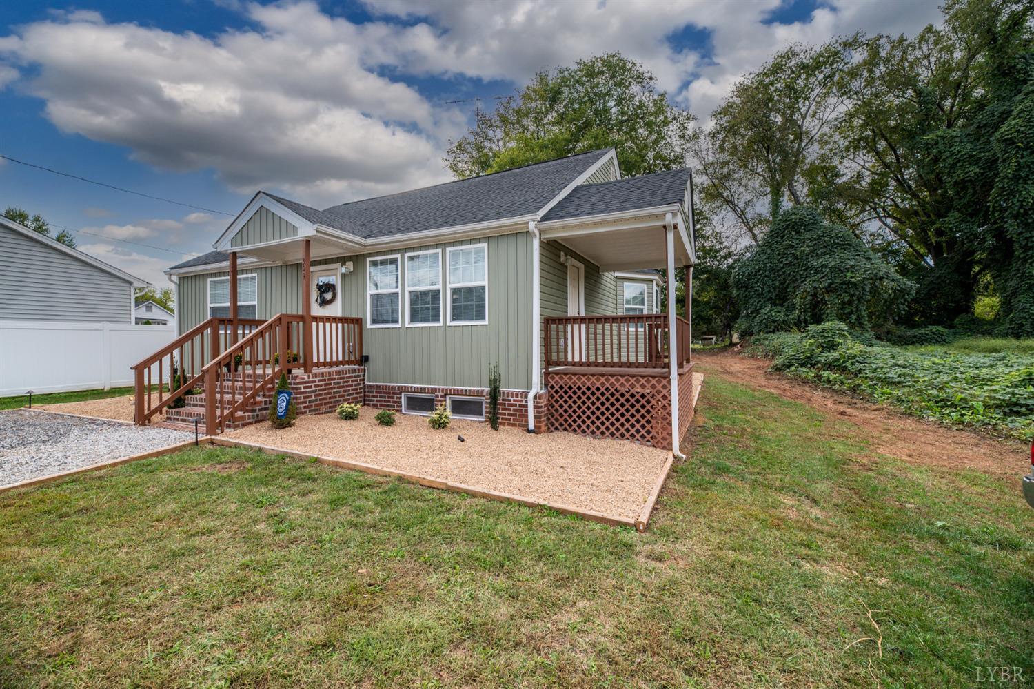 a view of a house with backyard porch and sitting area