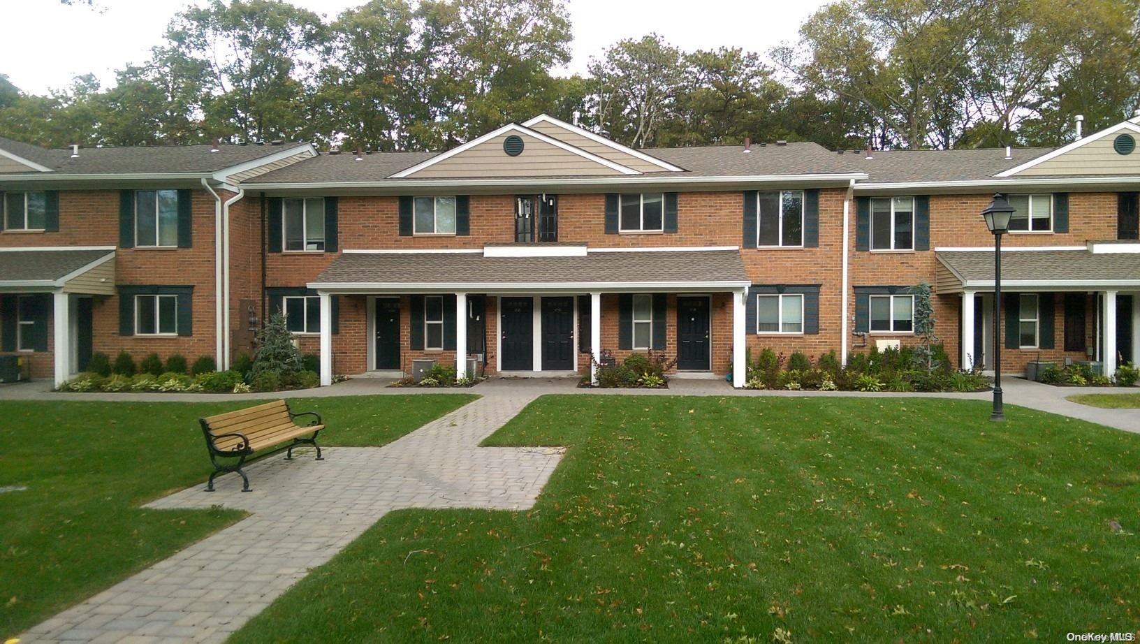 a front view of a house with a yard table and chairs