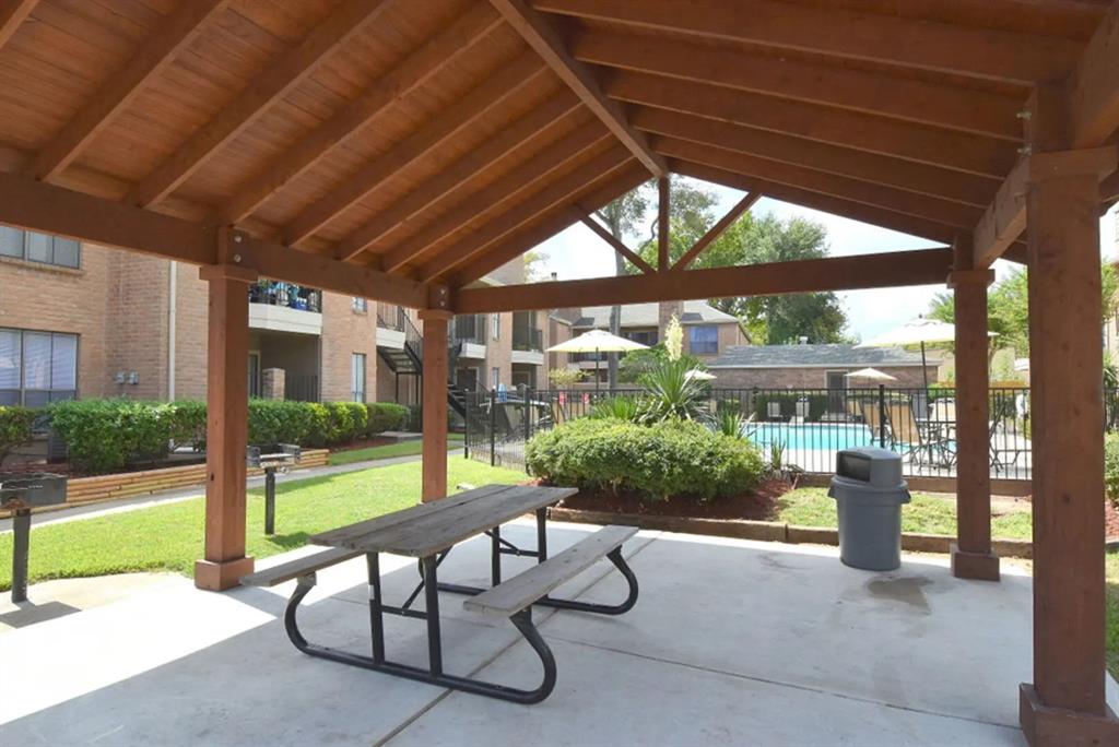 a view of a patio with a table and chairs