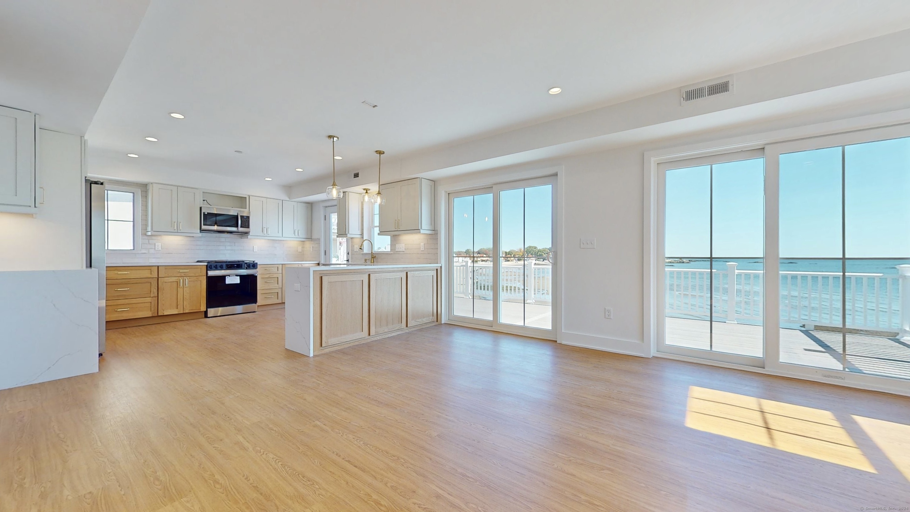 a view of a kitchen with wooden floor and a window