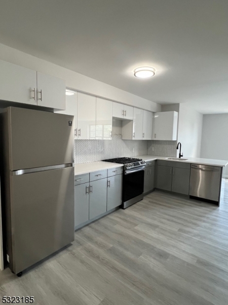 a kitchen with a refrigerator and a sink