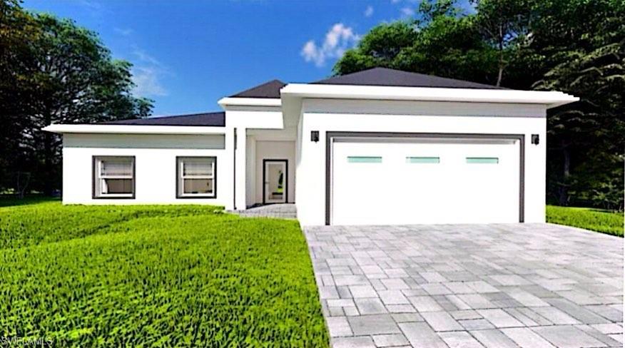 View of front facade with a garage and a front lawn