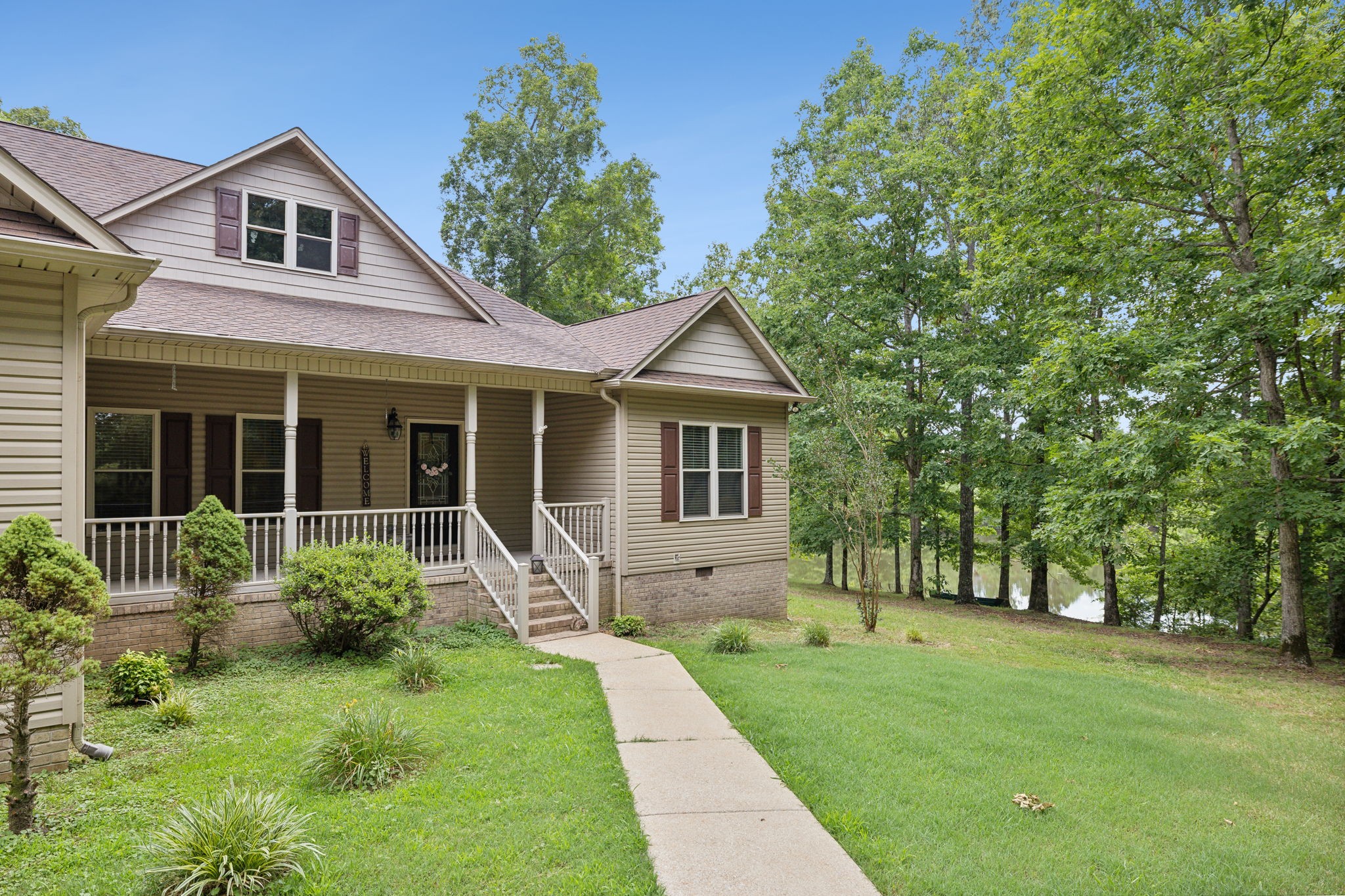 a front view of a house with garden and porch