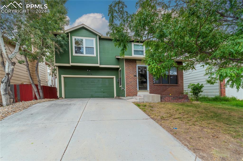 View of front of property featuring a garage