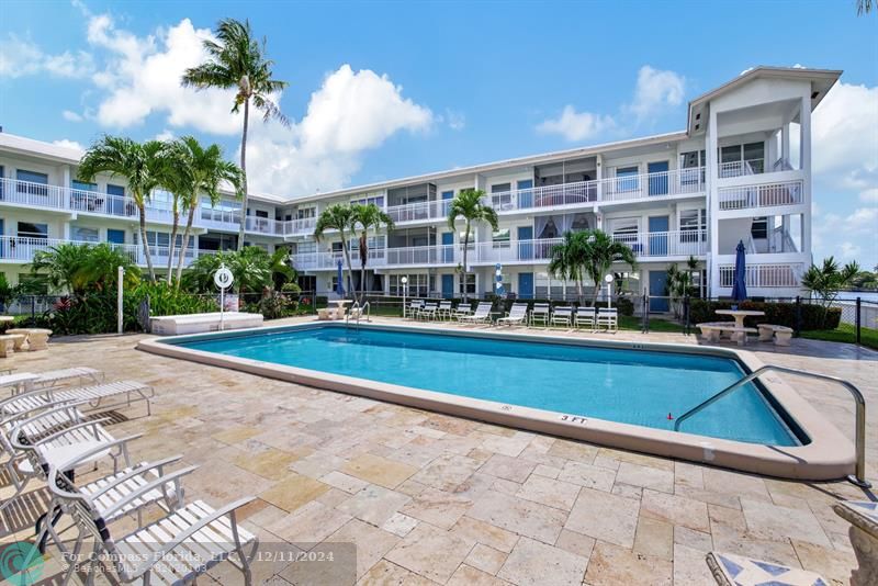 a swimming pool view with a outdoor seating