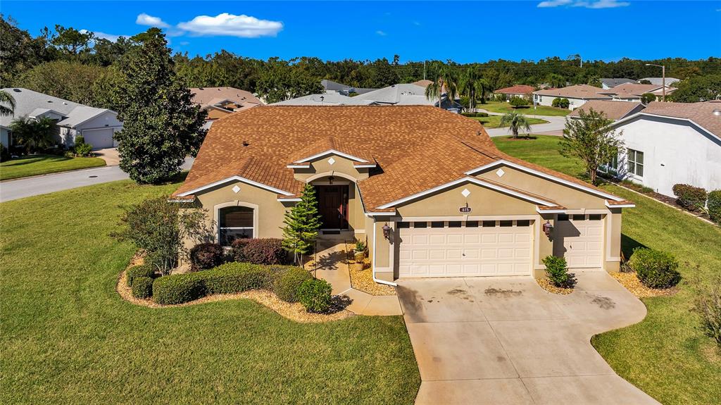 an aerial view of a house with a yard