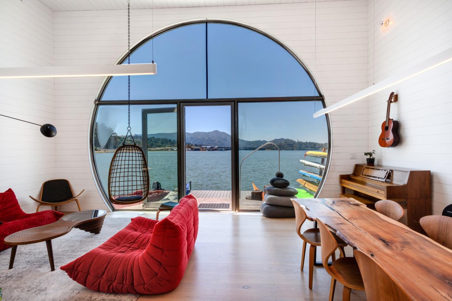 a living room with furniture and a floor to ceiling window