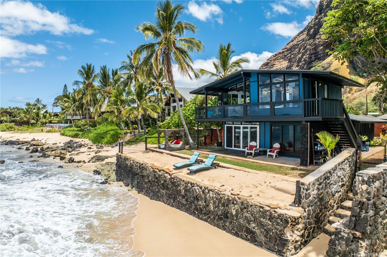 a view of a house with swimming pool and sitting area