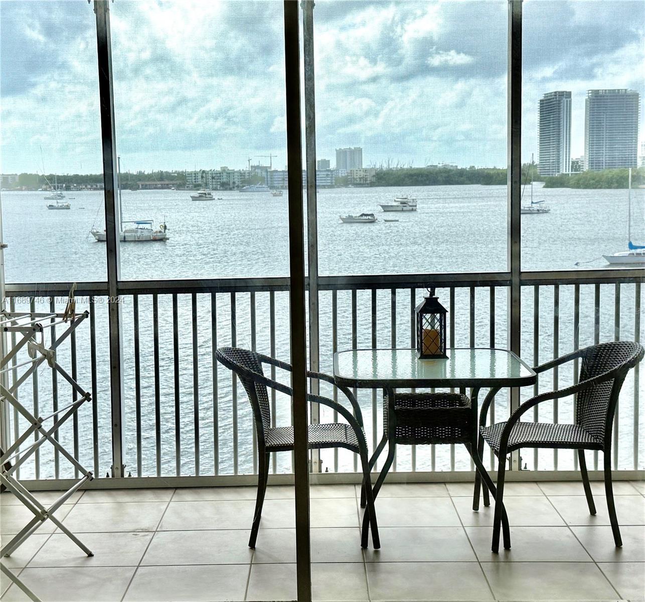 a view of a chairs and table in the balcony