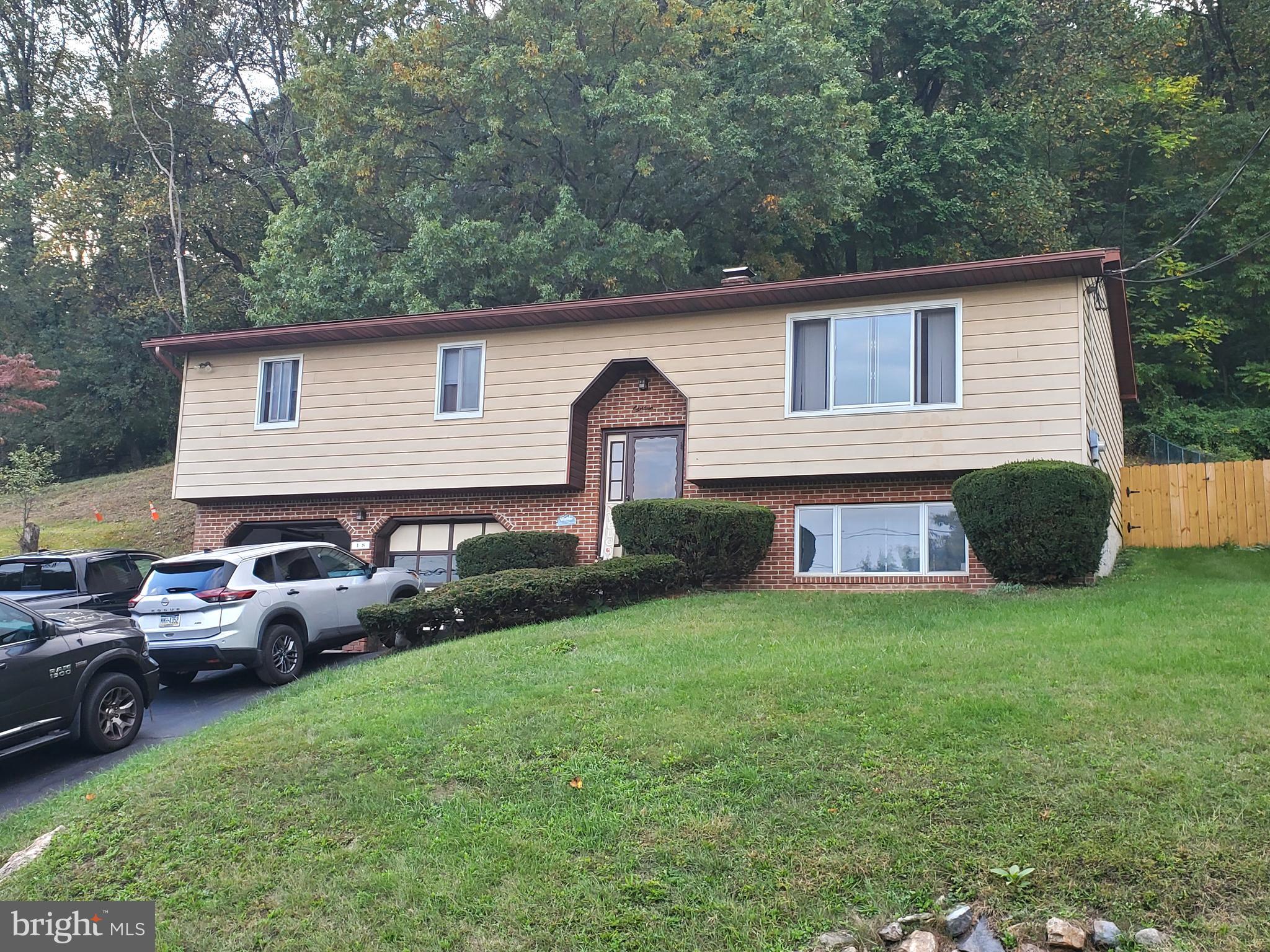 a front view of a house with a garden and yard